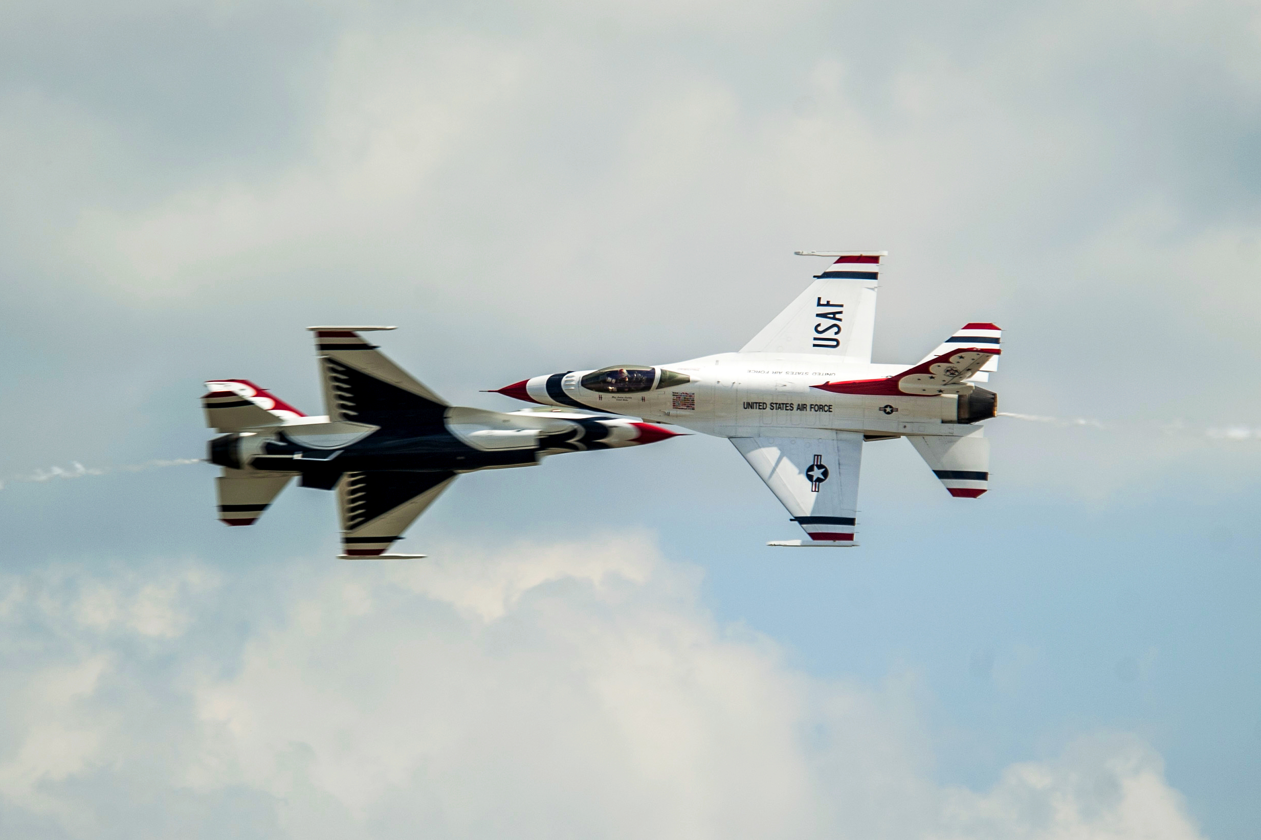 U.S. Air Force Thunderbirds pilots perform the opposing knifeedge hit