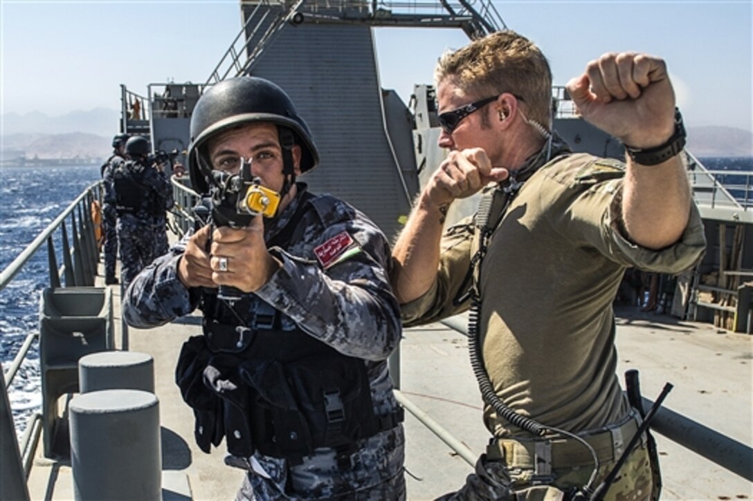 A U.S. Coast Guardsman and a Jordanian service member practice visit, board, search and seizure drills aboard Logistics Support Vessel James A. Loux during Eager Lion 2015 near a Jordanian naval base in the Gulf of Aqaba, Jordan, May 16, 2015. The Coast Guardsman is assigned to Maritime Security Response Team, Direct Action Section 2. 