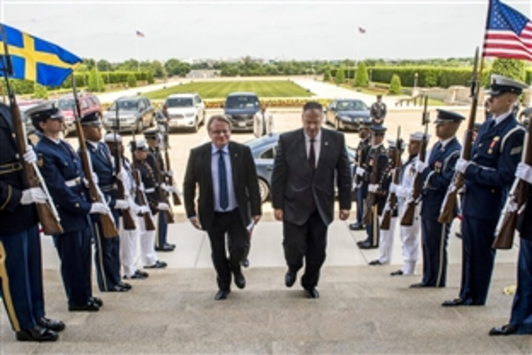 U.S. Deputy Defense Secretary Bob Work, right, hosts an honor cordon to welcome Swedish Defense Minister Peter Hultqvist to the Pentagon, May 20, 2015. The two defense leaders met to discuss matters of mutual importance.