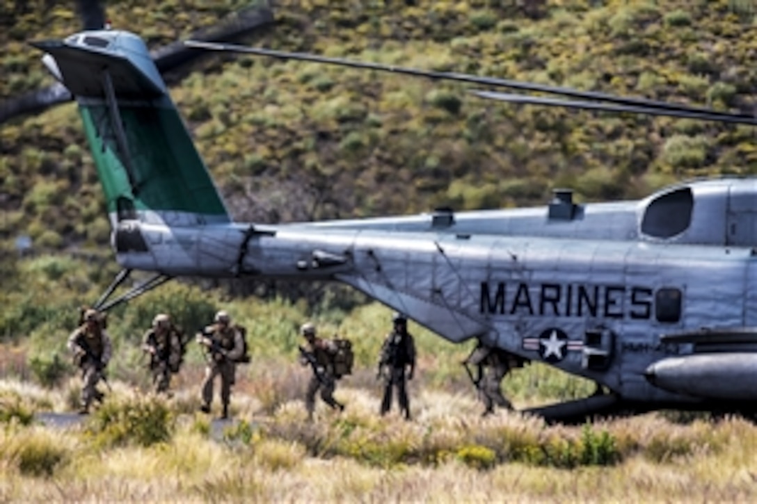 U.S. Marines exit a CH-53 Super Stallion helicopter to conduct an airfield seizure exercise on Bradshaw Airfield at a training area in Pohakuloa, Hawaii, May 19, 2015. The Marines are assigned to Charlie Company, 1st Battalion, 3rd Marine Regiment. The exercise is part of Operation Lava Viper. 