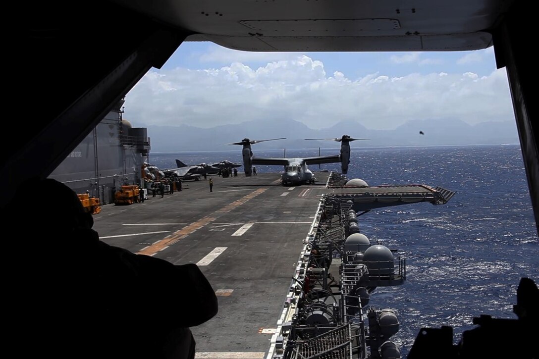 U.S. Marines with the 15th Marine Expeditionary Unit return to the USS Essex (LHD 2) in MV-22B Ospreys off the coast of Hawaii, May 19, 2015. These Marines demonstrated the capabilities of an amphibious raid during the U.S. Pacific Command Amphibious Leadership Symposium (PALS). PALS is designed to bring together senior leaders from allied and partner Marine Corps, naval infantries and militaries around the Pacific with interest in military amphibious capability development. (U.S. Marine Corps photo by Staff Sgt. Miguel Carrasco/Released)