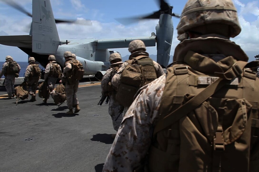 U.S. Marines with the 15th Marine Expeditionary Unit load onto an MV-22B Osprey aboard the USS Essex (LHD 2) off the coast of Hawaii, May 19, 2015. These Marines demonstrated the capabilities of an amphibious raid during the U.S. Pacific Command Amphibious Leadership Symposium (PALS). PALS is designed to bring together senior leaders from allied and partner Marine Corps, naval infantries and militaries around the Pacific with interest in military amphibious capability development. (U.S. Marine Corps photo by Staff Sgt. Miguel Carrasco/Released)