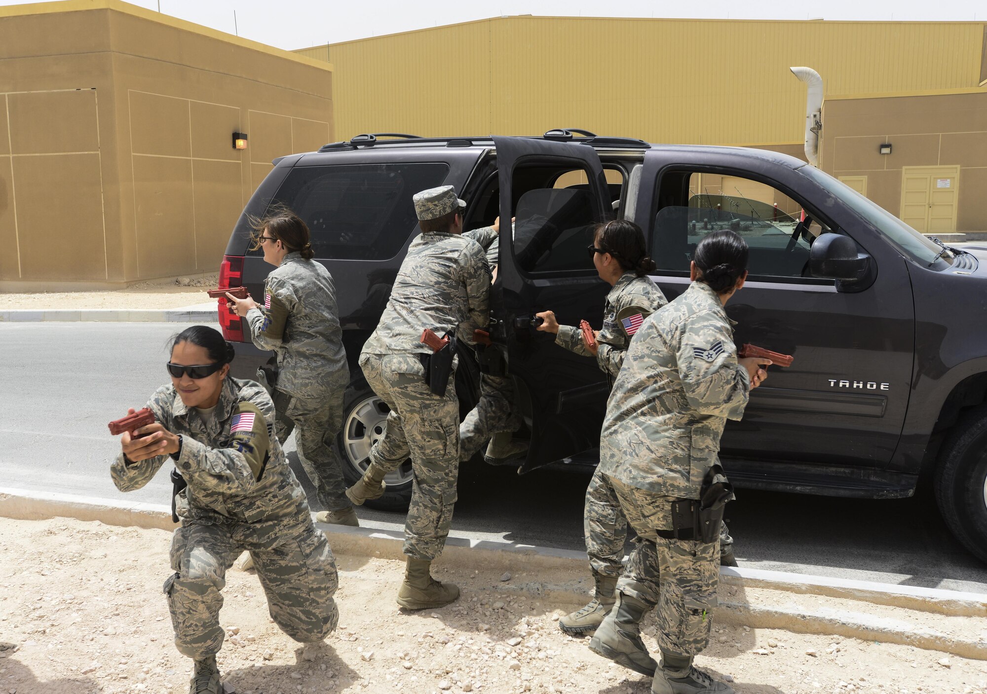 379th Expeditionary Security Forces Squadron female Airmen simulate removing their Very Important Person out of danger during Personal Security Detail training April 19, 2015, at Al Udeid Air Base, Qatar. The women of the 379th ESFS learned combatives, personal security detail procedures, treatment of combat trauma wounds, patient sustainment, and transportation.  (U.S. Air Force photo by Tech. Sgt. Caitlyn Thompson)
