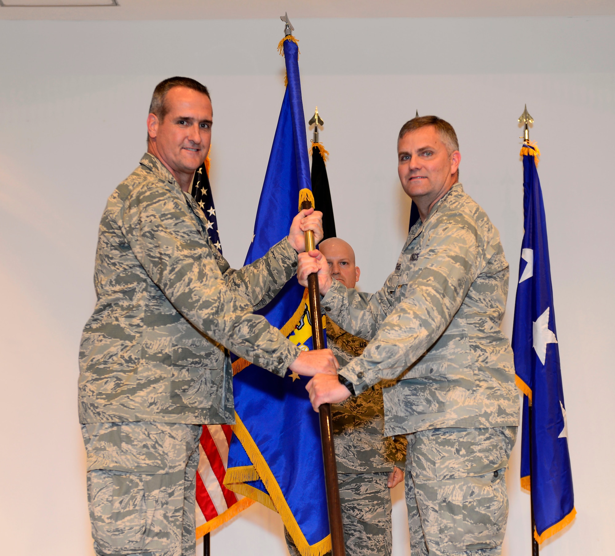 U.S. Maj. Gen. Peter Gersten,  Commander of the Ninth Air and Space Expeditionary Task Force, passes the guidon to Col. Michael Koscheski, the 332nd Air Expeditionary Wing commander, during an activation and assumption of command ceremony at an undisclosed location in Southwest Asia May 19, 2015. The 332nd AEW activated as the only combat wing within the Ninth AETF-L. (U.S. Air Force photo by Senior Airman Racheal E. Watson)