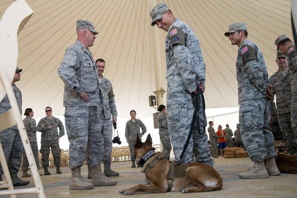 Members of the 379th Expeditionary Security Forces Squadron share a laugh with Airmen during their vehicle and weapons display May 12, 2015, at Memorial Plaza on Al Udeid Air Base, Qatar. The 379th ESFS held other various events during National Police Week consisting of an opening ceremony, a fallen officer memorial 5K run, and a "Defender Challenge".(U.S. Air Force photo by Tech. Sgt. Douglas)