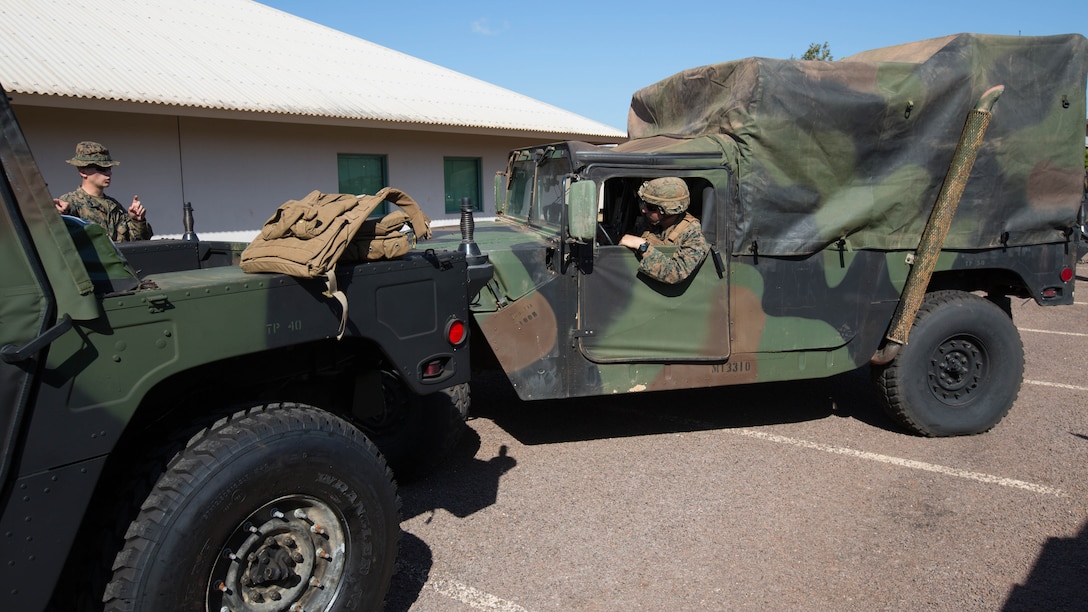 U.S. Marine Corps Lance Cpl. James Snyder, a rifleman, directs Lance Cpl. Douglas Nadeau, a rifleman, while putting into position a High Mobility Multipurpose Wheeled Vehicle for a convoy heading to Mount Bundey Training Area, Northern Territory, Australia, May 20. Marines with Marine Rotational Force- Darwin wrap up final details in order to set out for Exercise Predator Walk. Predator Walk plays a role in MRF-D that exercises a competent expeditionary fighting force with Australian allies. Snyder, a Plainwell, Michigan native, and Nadeau, a Belleville, Illinois native, are with Company C, 1st Marine Battalion, 4th Marine Regiment, MRF-D. 