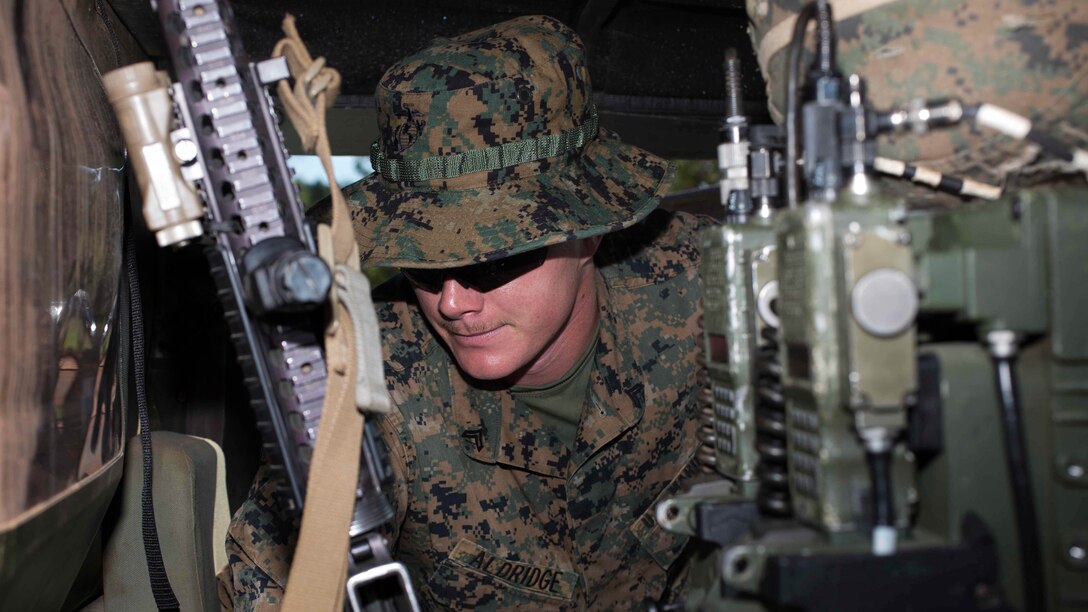 U.S. Marine Corps Cpl. Colby Albridge, an assaultman with Company A, 1st Battalion, 4th Marine Regiment,  Marine Rotational Force – Darwin, implements a final check on gear before leaving with a convoy to Mount Bundey Training Area, Northern Territory, Australia, May 20, 2015. The Marines were preparing the convoy to begin Exercise Predator Walk. This deployment demonstrates the interoperability and combined capability of a Marine Air Ground Task Force with Australian allies. Albridge is a native of Prescott Valley, Arizona. 