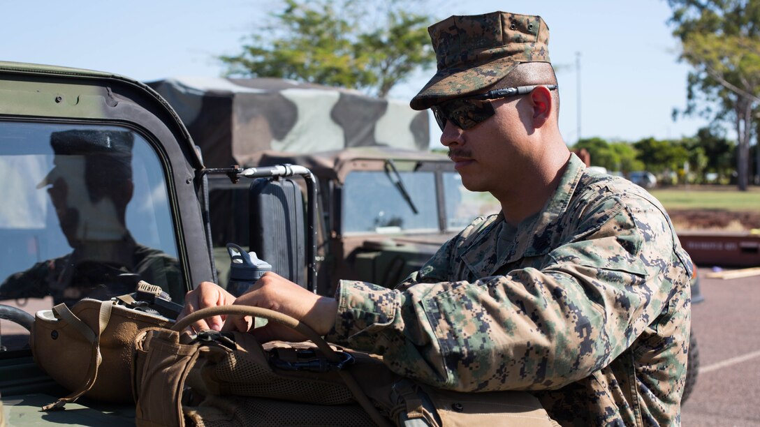 U.S. Marine Corps Sgt. Christopher Corpus, an explosive ordnance disposal technician with Combat Logistics Detachment 1, Marine Rotational Force- Darwin, inspects his gear before departing with a convoy to Mount Bundey Training Area, Northern Territory, Australia, May 20, 2015. Marines with MRF-D wrap up final details in order to set out for Exercise Predator Walk. Predator Walk plays a role in MRF-D that exercises a competent expeditionary fighting force with Australian allies. Corpus is a native of Reno, Nevada. 