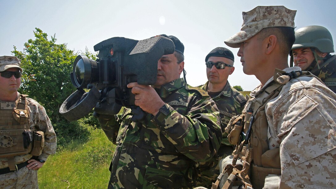 U.S. Marine Cpl. Michael Kness, antitank missileman with Black Sea Rotational Force, shows Romanian Maj. Gen. Cătălin Tomescu, commanding general of the 1st Infantry Division, the Command Launch Unit of a Javelin anti-tank missile system during the first day of Platinum Eagle 15, May 19. Approximately 150 U.S. Marines with Black Sea Rotational Force are partnering alongside their NATO Allies from Romania and Bulgaria for the two-week exercise hosted by the Romanians.