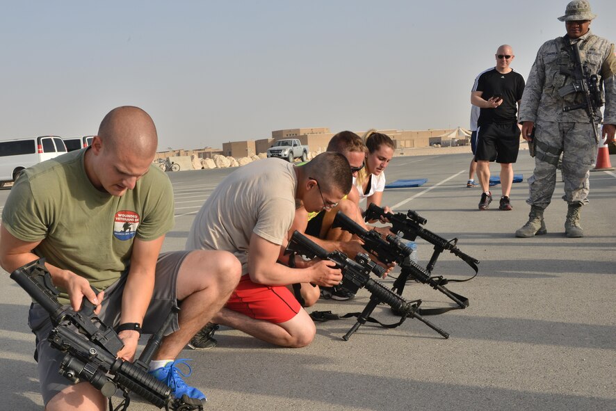 Al Udeid Police week Combat challenge participants are timed on weapon assembly as part of a combat challenge for National Police week May 14, 2015 at Al Udeid Air Base, Qatar. National Police was established to honor American law enforcement in 1962 to help gain recognition to officers that have lost their lives in the line of duty. (U.S. Air Force photo by Staff Sgt. Alexandre Montes)   