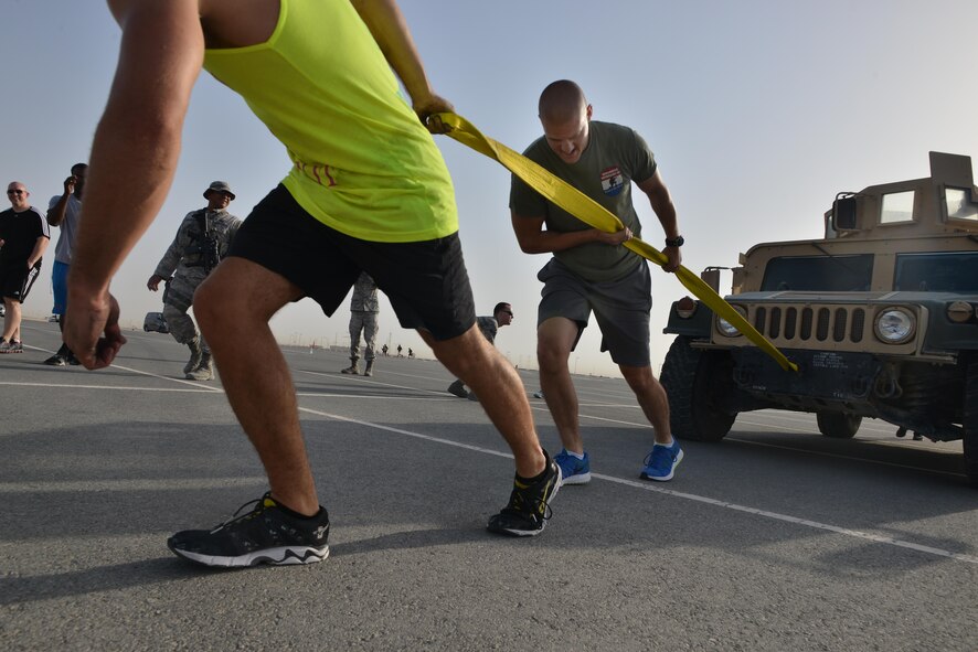 Staff Sgt. Jason Tinsley, 379th Expeditionary Security Forces Squadron pulls a Humvee as part of a combat challenge as part of National Police week event May 14, 2015 at Al Udeid Air Base, Qatar. National Police was established to honor American law enforcement in 1962 to help gain recognition to officers that have lost their lives in the line of duty. (U.S. Air Force photo by Staff Sgt. Alexandre Montes)   