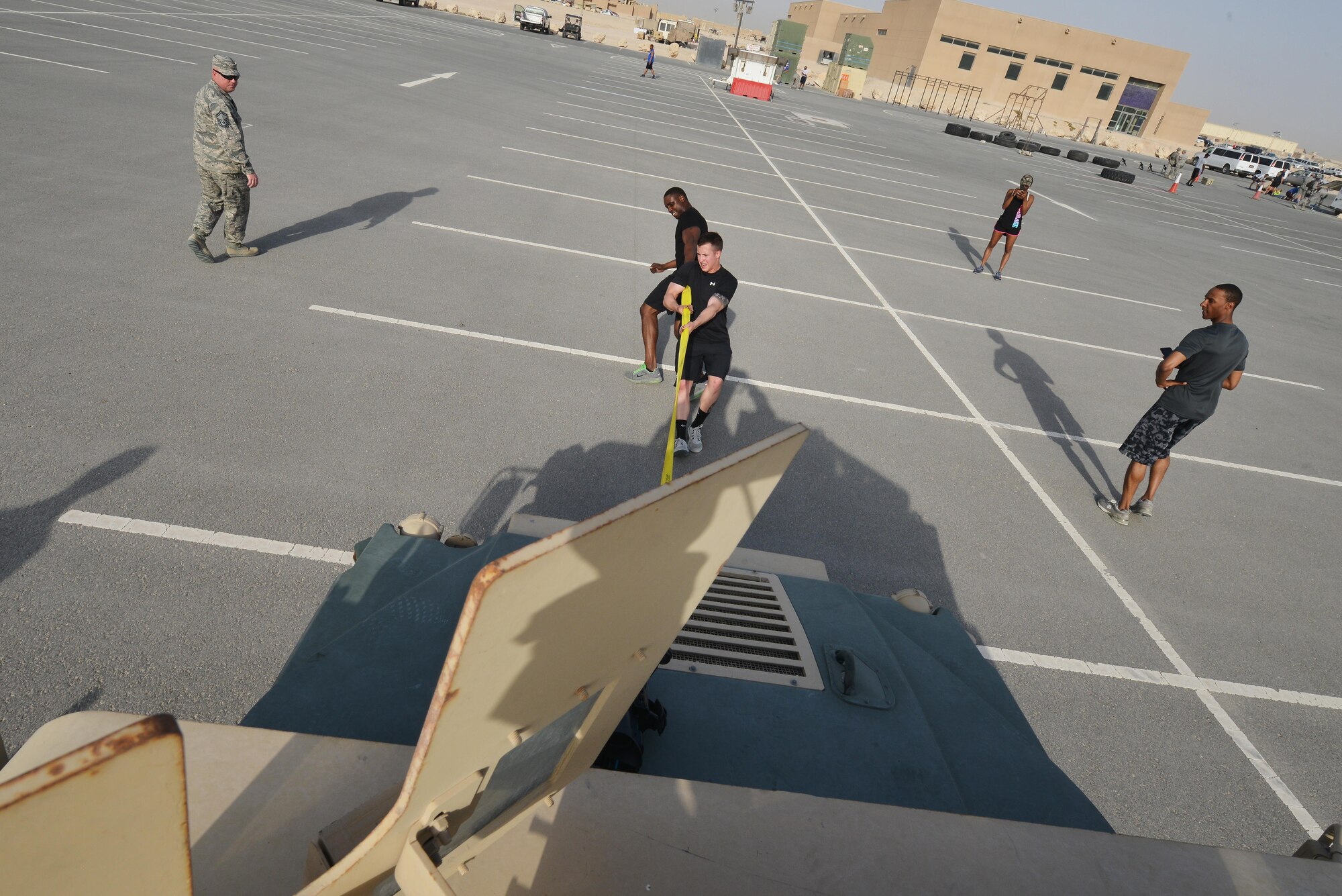 Tech. Sgt Cornelius Bostic and Airman 1st Class Corey Jimerson pull a Humvee for a combat challenge as part of National Police week event May 14, 2015 at Al Udeid Air Base, Qatar. National Police was established to honor American law enforcement in 1962 to help gain recognition to officers that have lost their lives in the line of duty. (U.S. Air Force photo by Staff Sgt. Alexandre Montes)    