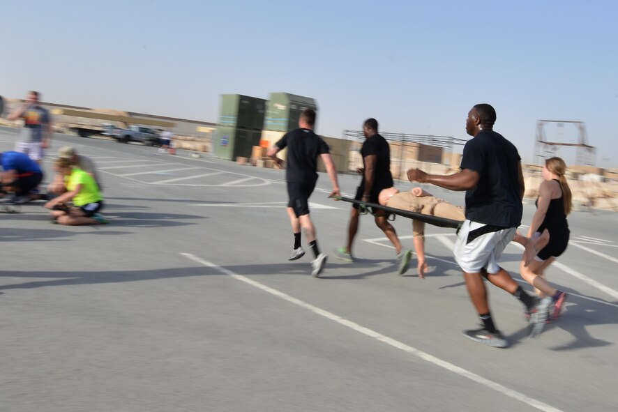 Airmen from the 379th Expeditionary Security Forces Squadron complete a litter carry relay during a combat challenge as part of National Police week event May 14, 2015 at Al Udeid Air Base, Qatar. National Police was established to honor American law enforcement in 1962 to help gain recognition to officers that have lost their lives in the line of duty. (U.S. Air Force photo by Staff Sgt. Alexandre Montes)   