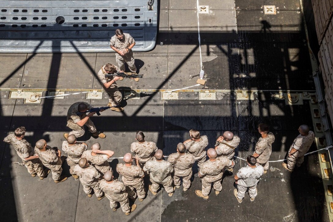 U.S. Marines with Kilo Company, Battalion Landing Team 3rd Battalion, 1st Marine Regiment, 15th Marine Expeditionary Unit, rehearse urban operations tactics aboard the USS Rushmore (LSD 47) at sea in the Pacific Ocean, May 15, 2015. While at sea the Marines continue training to maintain their proficiency at a wide variety of mission sets. (U.S. Marine Corps photo by Sgt. Emmanuel Ramos/Released)