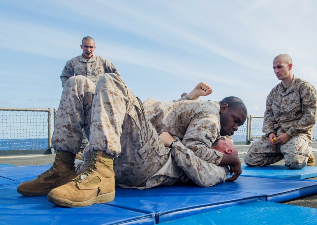 U.S. Marine Cpl. Heath Crouch, top, pratices ground fighting techniques with Lance Cpl. Nick Biglione during Marine Corps Martial Arts Program training aboard the USS Rushmore (LSD 47) at sea in the Pacific Ocean, May 13, 2015. Crouch is an intelligence specialist and Biglione is a rifleman with Kilo Company, Battalion Landing Team 3rd Battalion, 1st Marine Regiment, 15th Marine Expeditionary Unit. The 15th MEU is currenlty deployed aboard the Essex Amphibious Ready Group. (U.S. Marine Corps photo by Sgt. Emmanuel Ramos/Released)