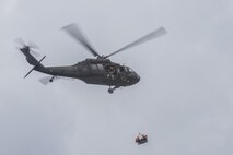 Members of the 39th Flying Training Squadron are hoisted up to a UH-60 Blackhawk May 7, 2015, at Canyon Lake, Texas, during helicopter search and rescue training. Members of the 39th FTS trained with members of the Texas Army National Guard and local agencies to remain proficient in water survival practices. (U.S. Air Force photo by Airman 1st Class Stormy Archer)