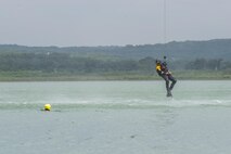 A rescue swimmer is lowered to the water during a helicopter search and rescue training event May 7, 2015, at Canyon Lake, Texas. Members of the 39th Flying Training Squadron, along with the Texas Army National Guard, Texas Task Force 1 and the Texas Parks and Wildlife Department trained together to remain proficient water rescue and survival techniques. (U.S. Air Force photo by Airman 1st Class Stormy Archer)