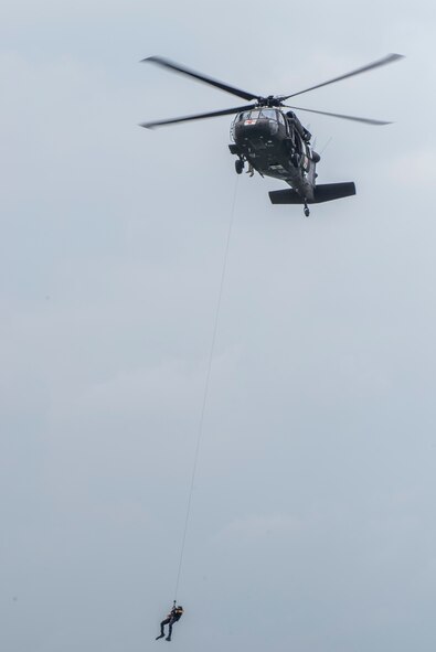 A rescue swimmer is lowered to the water during a helicopter search and rescue training event May 7, 2015, at Canyon Lake, Texas. Members of the 39th Flying Training Squadron, along with the Texas Army National Guard, Texas Task Force 1 and the Texas Parks and Wildlife Department trained together to remain proficient water rescue and survival techniques. (U.S. Air Force photo by Airman 1st Class Stormy Archer)