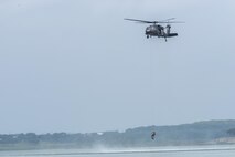 A rescue swimmer is lowered to the water during a helicopter search and rescue training event May 7, 2015, at Canyon Lake, Texas. Members of the 39th Flying Training Squadron, along with the Texas Army National Guard, Texas Task Force 1 and the Texas Parks and Wildlife Department trained together to remain proficient water rescue and survival techniques. (U.S. Air Force photo by Airman 1st Class Stormy Archer)