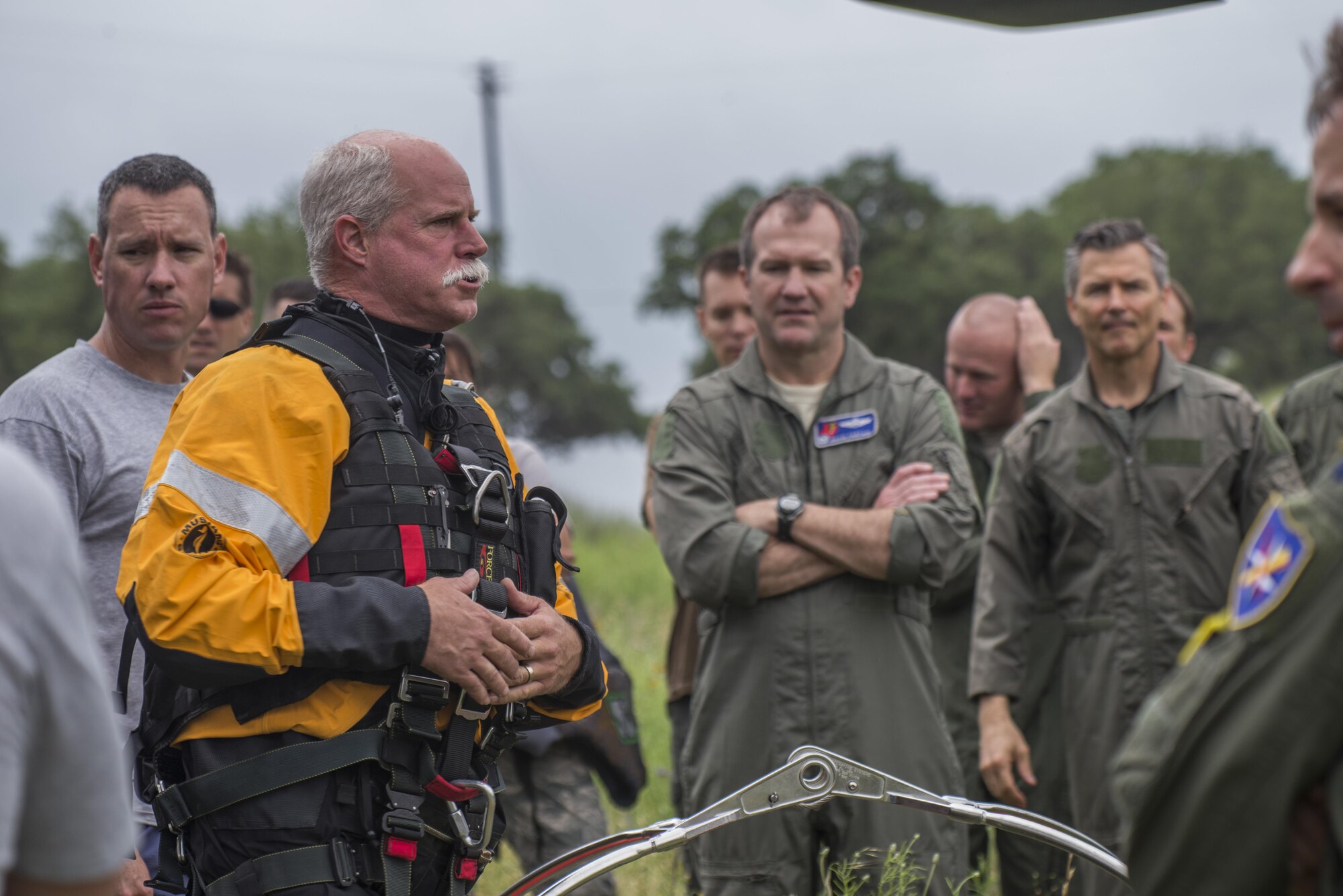 Ken Larson, Texas Task Force 1 helicopter rescue swimmer, gives a safety briefing to members of the 39th Flying Training Squadron before a helicopter search and rescue training event May 7, 2015, at Canyon Lake, Texas. Members of the 39th FTS trained with members of the Texas Army National Guard and local agencies to remain proficient in water survival practices. (U.S. Air Force photo by Airman 1st Class Stormy Archer)