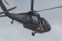 Members of the 39th Flying Training Squadron are hoisted up to a UH-60 Blackhawk May 7, 2015, at Canyon Lake, Texas, during helicopter search and rescue training. Members of the 39th FTS trained with members of the Texas Army National Guard and local agencies to remain proficient in water survival. (U.S. Air Force photo by Airman 1st Class Stormy Archer)