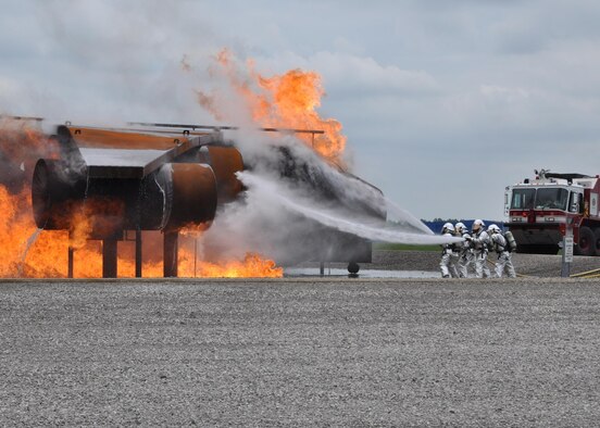 Members of the 910th Civil Engineer Fire Department battle a blaze on a training aircraft as part of a capabilities demonstration here May 16, 2015. The Fire Department displayed their capabilities for approximately 250 Arrowmen here for a Boy Scouts of America Order of the Arrow conclave. During the conclave, the Scouts experienced the military lifestyle through several displays and demonstrations by Youngstown Air Reserve Station Personnel. (U.S. Air Force photo/Chief Master. Sgt. David Prokop)