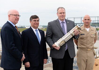 Deputy Secretary of Defense Bob Work takes a photo with the hypervelocity projectile that will be fired at the Naval Surface Warfare Center, Dahlgren, VA on April 30, 2015.