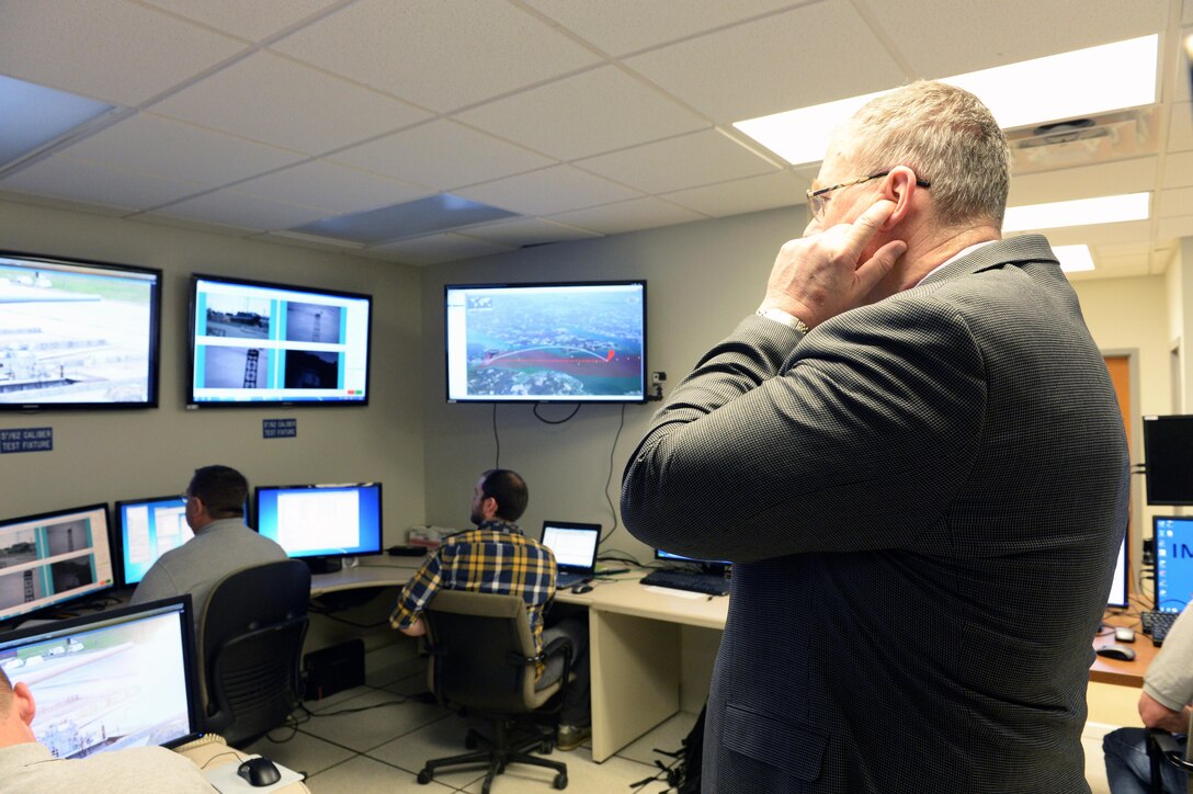 Deputy Secretary of Defense Bob Work plugs his ears in anticipation of the hypervelocity projectile being fired at the Naval Surface Warfare Center Dahlgren Division, Dahlgren, VA on April 30, 2015.