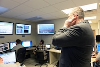 Deputy Secretary of Defense Bob Work plugs his ears in anticipation of the hypervelocity projectile being fired at the Naval Surface Warfare Center Dahlgren Division, Dahlgren, VA on April 30, 2015.