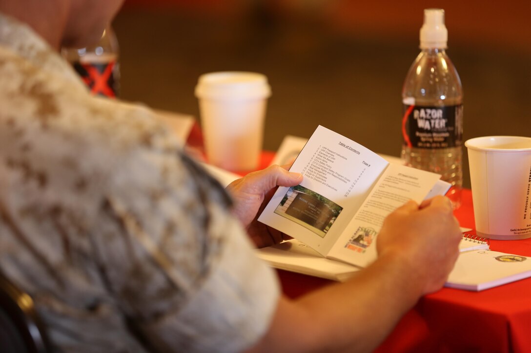 A Marine holds a pamphlet during the Marine Installations Board aboard Marine Corps Air Station Miramar, California, May 19. Installation commanders provide insight during the board to ensure the goal of supporting their bases’ civilian workers, Marines, Sailors and their families during the board.
