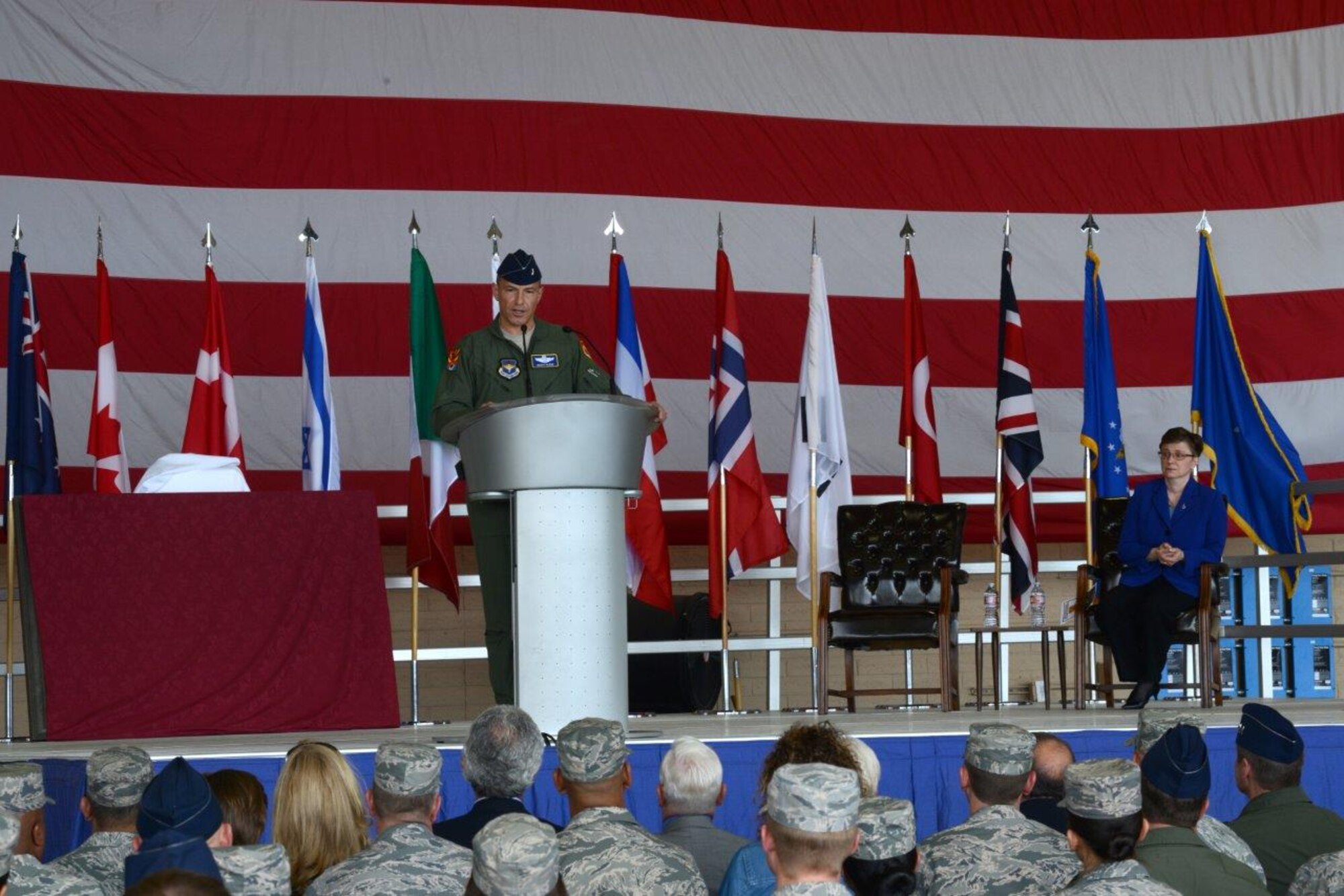 Brig. Gen. Scott Pleus, 56th Fighter Wing commander, speaks during the 56th FW change of mission ceremony May 21, 2015, at Luke Air Force Base, Arizona. Lorraine Martin, Lockheed Martin Executive Vice President and General Manager of the F-35 Lighting II Program, also spoke about the significance of the change of mission and Lockheed Martin’s role at Luke training F-35 pilots. (U.S. Air Force photo by Airman Pedro Mota)