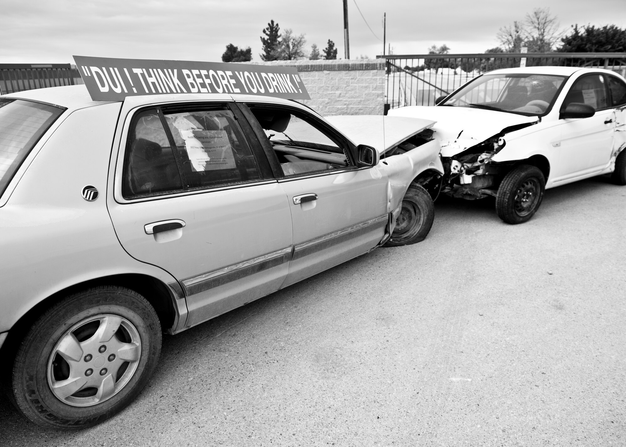 Two crashed vehicles sit outside the gates of Holloman Air Force Base, N.M. May 21, 2015. The vehicles, which were placed there by the 49th Wing Safety Office, were both wrecked as a result of drinking and driving. The consequences of drinking and driving include personal injury, loss of job, loss of driving privileges, or worst of all: death. As the 4-day weekend approaches, Holloman leadership encourages all Airmen to have a plan before drinking, and a back-up plan in case the original plan falls through. If all else fails, Holloman has a program called 572-RIDE that volunteers from around base operate every weekend. To reach 572-RIDE call 575-572-7433 or 575-572-1110:ext. 5. (U.S. Air Force Photo Illustration by Senior Airman Chase Cannon/ Released) 