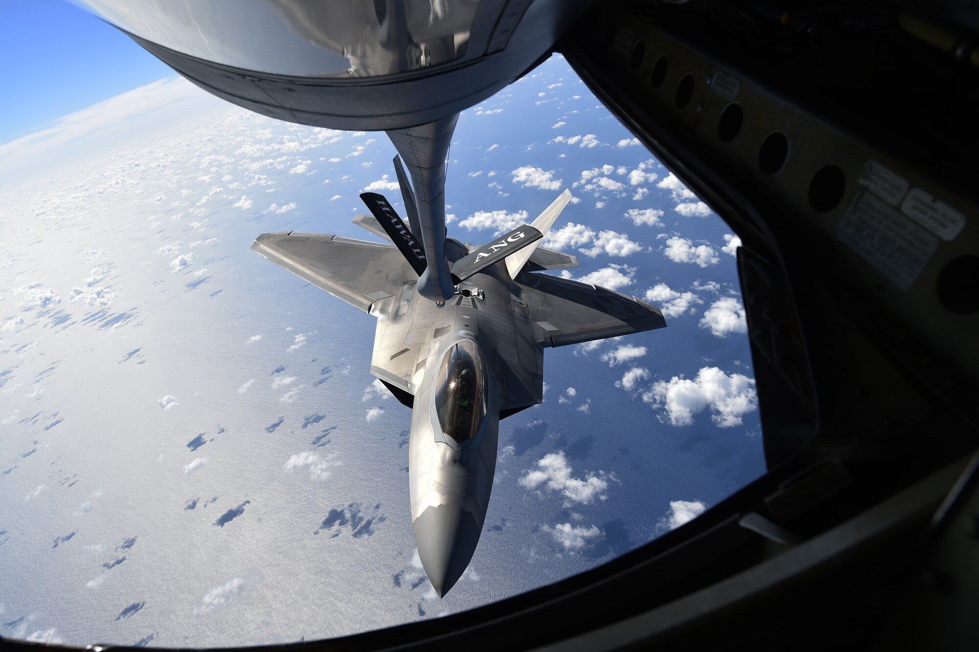 A F-22 Raptor, from the Hawaiian Raptors, prepares to receive fuel during an in-air refueling from a KC-135R Stratotanker from the 96th Air Refueling Squadron over Hawaii, May  19, 2015. The F-22 is the Air Force’s fifth generation fighter aircraft that combination of stealth, supercruise, maneuverability, and integrated avionics, coupled with improved supportability, represents an exponential leap in warfighting capabilities. (U.S. Air Force photo by Tech. Sgt. Aaron Oelrich/Released)