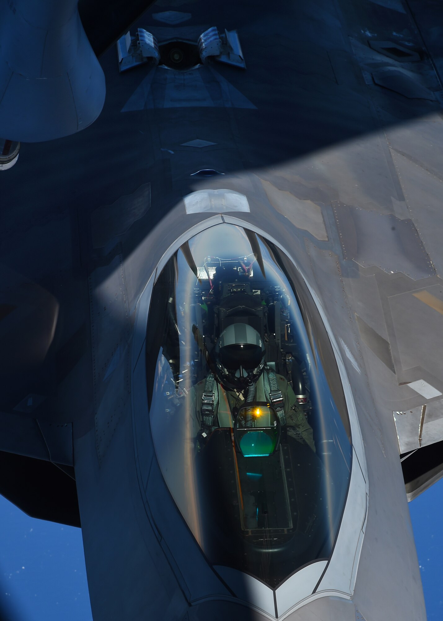 A pilot from the Hawaiian Raptors guides the F-22 Raptor into position during aerial refueling operations with the 96th Air Refueling Squadron’s KC-135R Stratotanker over Hawaii, May 19, 2015. The F-22 is the Air Force’s fifth generation fighter aircraft. (U.S. Air Force photo by Tech. Sgt. Aaron Oelrich/Released) 