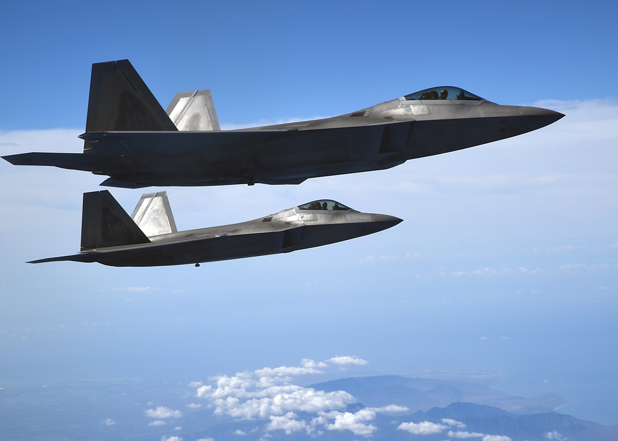 United States Air Force F-22 Raptors, from the Hawaiian Raptors, fly in formation above the island of Oahu, Hawaii, May 19, 2015. The F-22 pilots conducted aerial refueling operations with the 96th Air Refueling Squadron’s KC-135R Stratotanker. The F-22 Raptor is a fighter aircraft that combines stealth, supercruise, maneuverability, and integrated avionics, coupled with improved supportability, to represent an exponential leap in warfighting capabilities. (U.S. Air Force photo by Tech. Sgt. Aaron Oelrich/Released) 