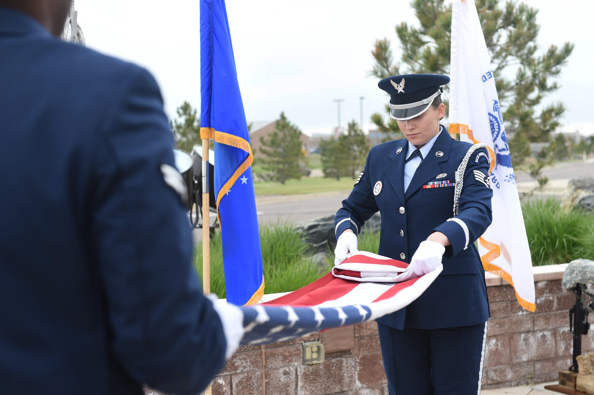 The Mile High Honor Guard retreat the colors during Buckley Air Force Base’s Memorial Day ceremony May 21, 2015, at the headquarters building on Buckley AFB, Colo. The ceremony included a formation, a guest speaker who spoke on his experiences during the Vietnam War, and a retreat ceremony. (U.S. Air Force photo by Airman 1st Class Samantha Meadors/Released)