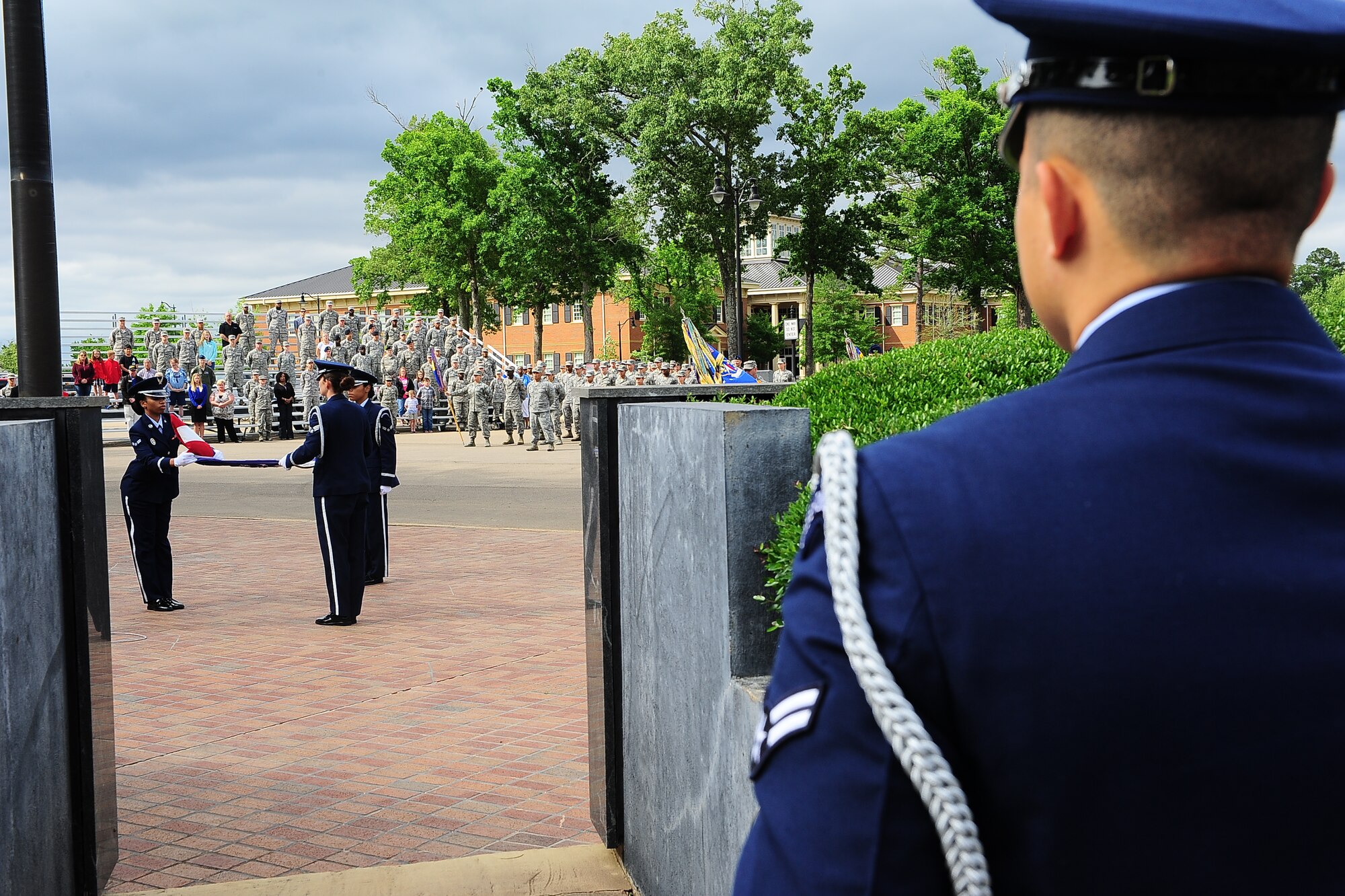14th Flying Training Wing Honor Guardsmen fold the base flag before retiring it at a 14 FTW Memorial Day retreat May 21, 2014 on Columbus Air Force Base, Mississippi. After retiring the flag, formations of Airmen paused for a moment of silence before saluting to honor the fallen while Taps was played. (U.S. Air Force photo/Airman Daniel Lile)