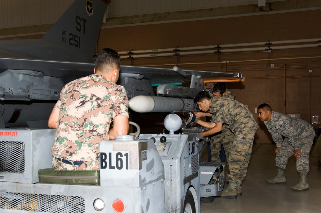 U.S. Air Force Staff Sgt. Louis Carranza, 363rd Training Squadron instructor, teaches 2nd Lt. Saddam Alshloul, (Jordan), 1st Lt. Hayder Khafaji, (Iraq), Tech. Sgt. Murat Doner, (Turkey), and Staff Sgt. Hamza Varinli, (Turkey), how to conduct loading procedures for the F-16 Fighting Falcon Aircraft Armament Course, May 20, 2015, at Sheppard Air Force Base, Texas. Carranza conducts this course semi-annually and believes it is a great opportunity for other countries to receive training and strengthen the international relations between the U.S. and other nations. (U.S. Air Force photo by Danny Webb/Released)