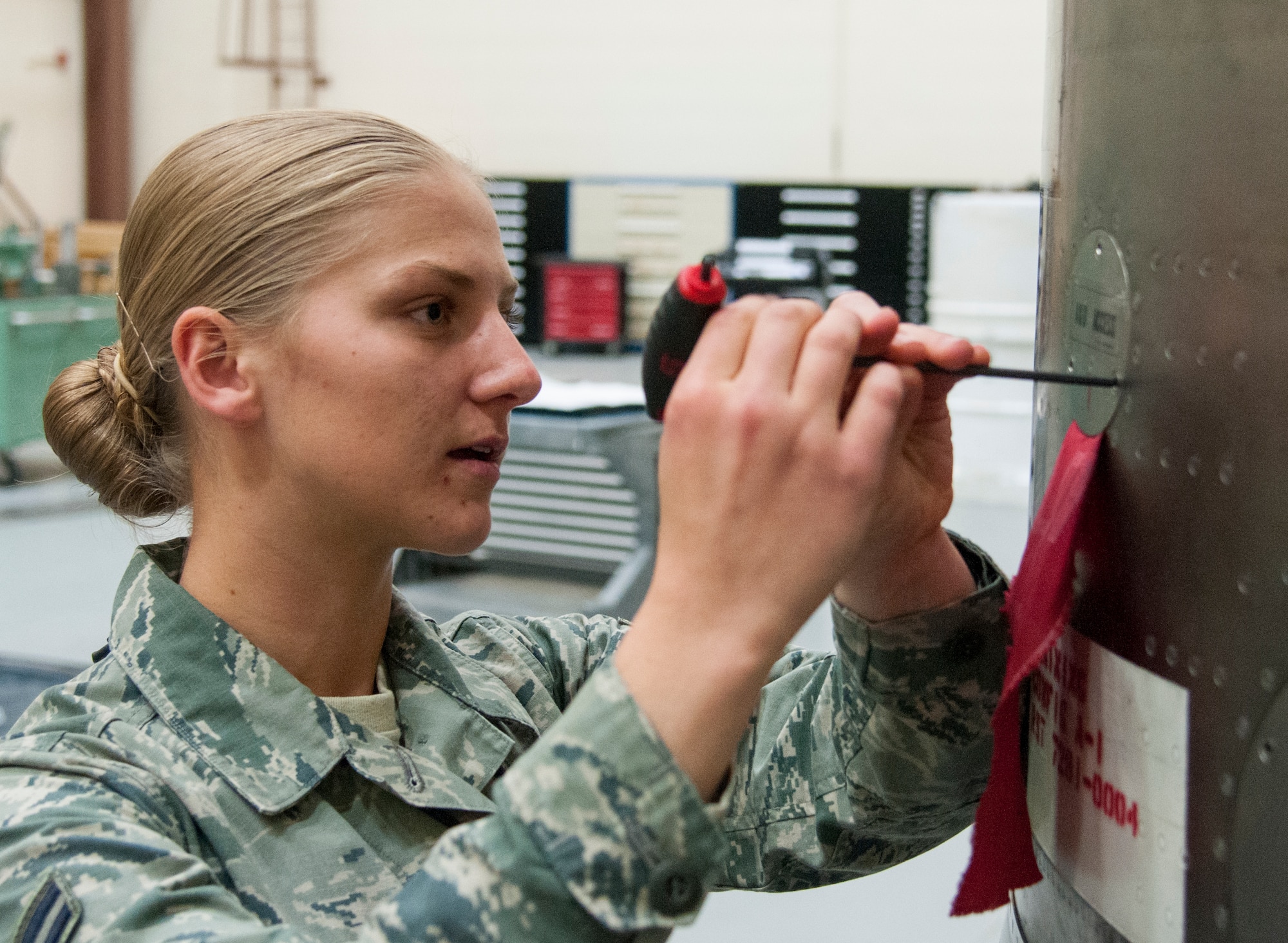 Airman 1st Class Alexis Visser, 90th Munitions Squadron reentry system/reentry vehicle team member, makes adjustments to the aft shroud of a Minuteman III ICBM on F.E. Warren Air Force Base, Wyo., May 19, 2015. Maintainers such as Visser require months of training before they can be certified to perform real maintenance operations. (U.S. Air Force photo by Senior Airman Jason Wiese)