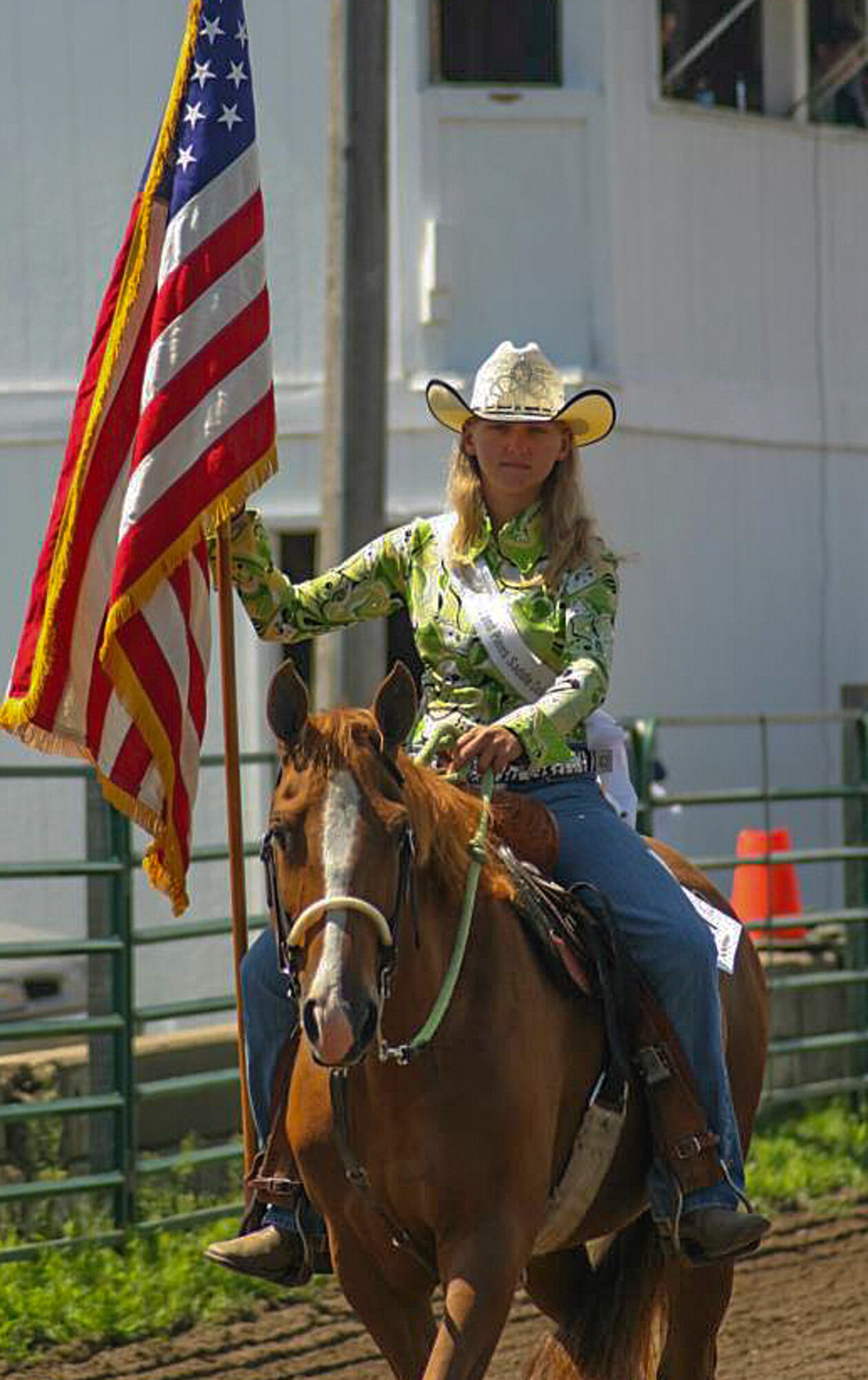 Alexis Visser, Pequot Lakes, Minn., resident and avid horse rider, carries the flag during the playing of the “Star Spangled Banner” at the Crow Wing County Fair in 2013. Visser currently works in the 90th Munitions Squadron on F.E. Warren Air Force Base, Wyo. (Courtesy photo)