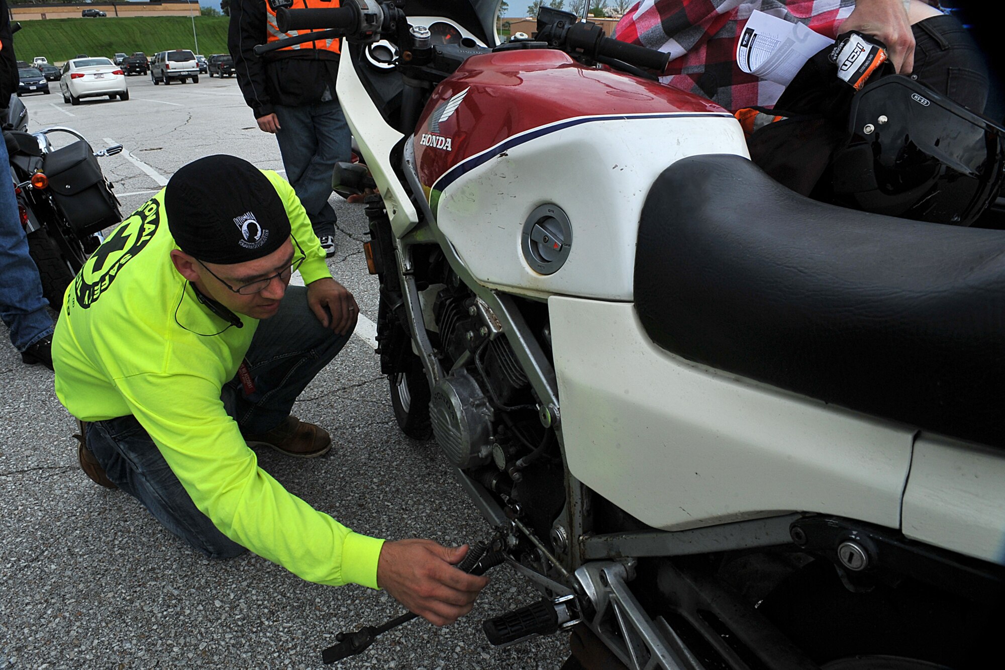 U.S. Air Force Tech. Sgt. Edward J. Lotz, with the 55th Aircraft Maintenance Squadron, inspects a 1984 Honda interceptor in the lower STRATCOM parking lot at Offutt AFB, Neb., May 15. As part of the Comprehensive Airman Fitness Day motorcycle riders in the 55th AMXS attended a motorcycle safety course that included the Tires and Wheels, Controls, Lights and Electrical, Oil and Fluids, Chassis and Side stand or “T-CLOCS” pre-ride inspection (U.S. Air Force photo by Charles J. Haymond/Released)