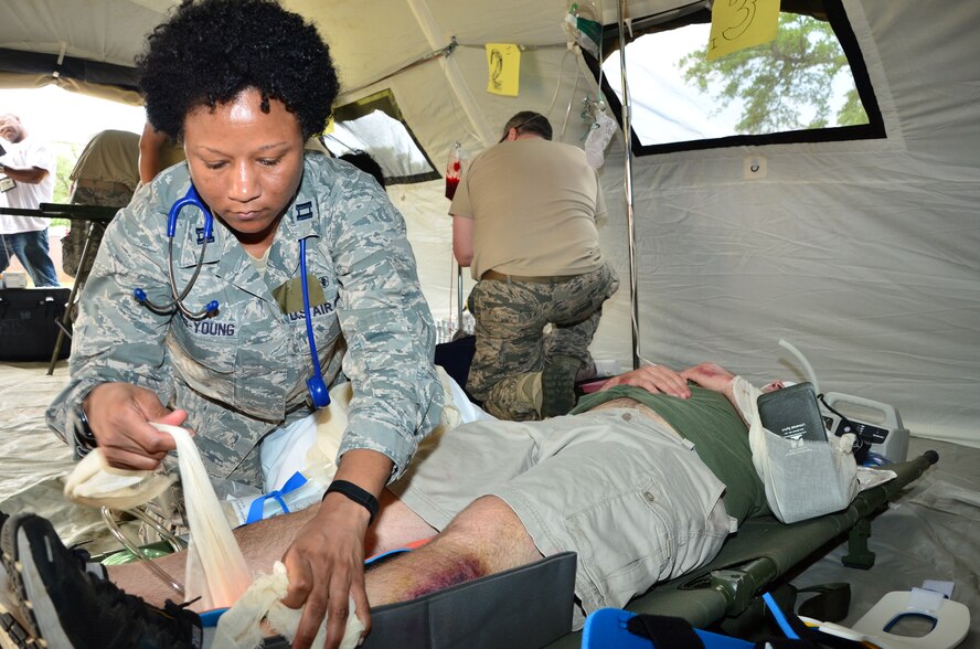 Capt. Angela Lewis-Young, a nurse with the 403rd Aeromedical Staging Squadron dresses a patient's wounds during Operation Sundown at Keesler Air Force Base, May 14.