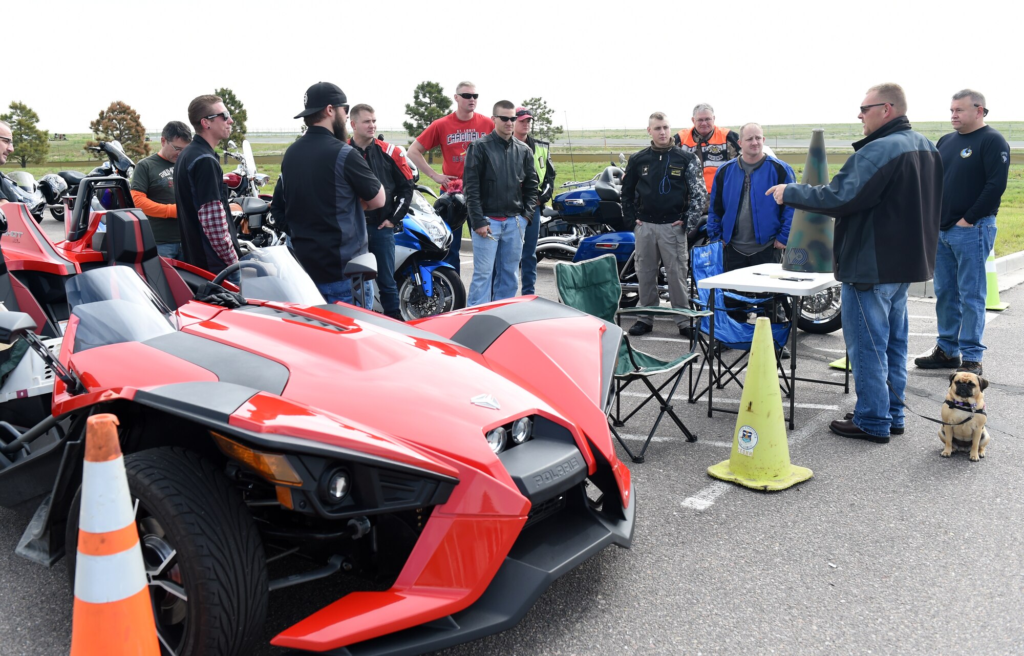 Donald Wood, 460th SCS information technology specialist, second from right; gives a safety briefing before their motorcycle safety ride May 15, 2015, on Buckley Air Force Base, Colo. The 460th SCS had this motorcycle ride to give “on-the-job” training to ensure young members of the squadron know how to ride safely. (U.S. Air Force photo by Airman 1st Class Emily E. Amyotte/Released)