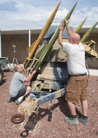 Curtis Klitzka 547th Intelligence Squadron sheet metal painter, and Doug Tolfree, 547th IS heavy equipment vehicle maintenance, work on a Rapier air defense system at the 547th IS Threat Systems Yard on Nellis Air Force Base Nev, May 14, 2015. The threat systems yard was established in 1976 as the U.S. Air Force’s premier hands-on threat training facility. (U.S. Air Force photo by Airman 1st Class Rachel Loftis) 