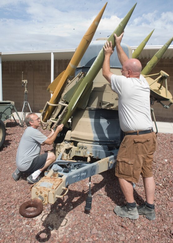 Curtis Klitzka 547th Intelligence Squadron sheet metal painter, and Doug Tolfree, 547th IS heavy equipment vehicle maintenance, work on a Rapier air defense system at the 547th IS Threat Systems Yard on Nellis Air Force Base Nev, May 14, 2015. The threat systems yard was established in 1976 as the U.S. Air Force’s premier hands-on threat training facility. (U.S. Air Force photo by Airman 1st Class Rachel Loftis) 