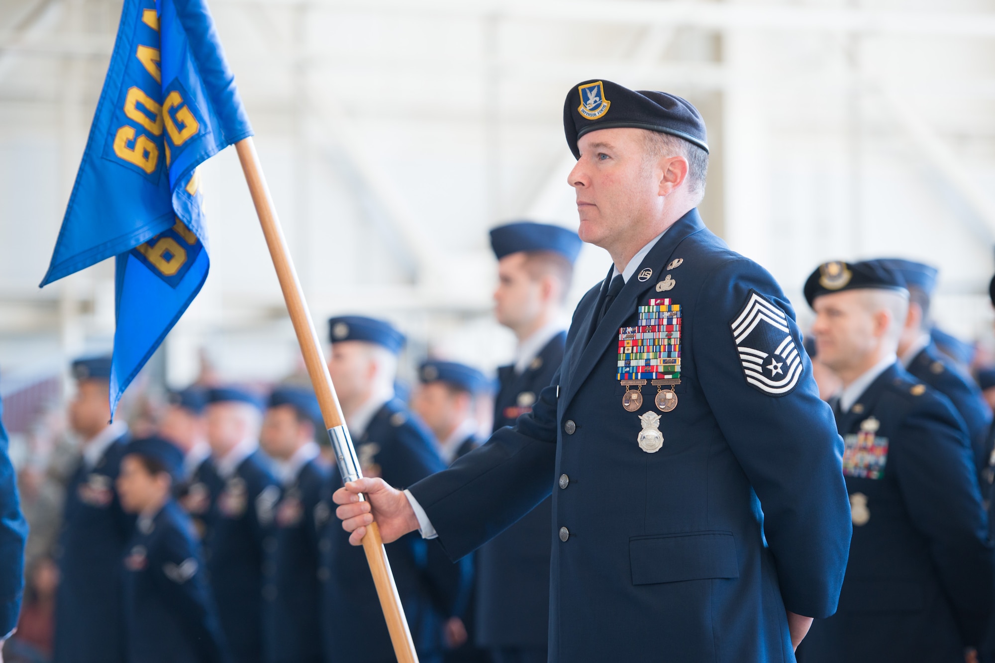 Chief Master Sgt. Mike Yoakum, 60th Mission Support Group superintendent, holds his unit's guidon during the 60th Air Mobility Wing change of command ceremony Feb. 20 at Travis Air Force Base, Calif. Yoakum retired May 15 after 30 years of service. (U.S. Air Force photo by Ken Wright)