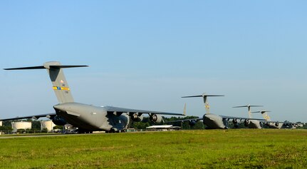 U.S. Air Force C-17 Globemaster III's take off from Joint Base Charleston, S.C. May 21, 2015 during exercise CRESCENT REACH 15. This exercise tested and evaluated Joint Base Charleston's ability to launch a large aircraft formation in addition to processing and deploying duty passengers and cargo in response to a simulated crisis abroad. The 437th Airlift Wing launched 11 aircraft as part of the multi-ship formation that flew to Pope AFB, North Carolina. There they joined four additional C-17s, six C-130s, E-8 JSTARS and two F-16s to participate in the 82nd Airborne Division's All American Week. During their time there, more than 1,400 paratroopers and critical equipment, such as HUMVEES and artillery, were dropped to simulate a Joint Forcible Entry of the Global Response Force. All American Week is the Division's premiere event to maintain close ties with Division Veteran's as well as celebrate heritage and unit cohesion. (U.S. Air Force photo by Senior Airman Nicholas Byers)