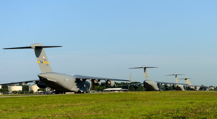 U.S. Air Force C-17 Globemaster III's take off from Joint Base Charleston, S.C. May 21, 2015 during exercise CRESCENT REACH 15. This exercise tested and evaluated Joint Base Charleston's ability to launch a large aircraft formation in addition to processing and deploying duty passengers and cargo in response to a simulated crisis abroad. The 437th Airlift Wing launched 11 aircraft as part of the multi-ship formation that flew to Pope AFB, North Carolina. There they joined four additional C-17s, six C-130s, E-8 JSTARS and two F-16s to participate in the 82nd Airborne Division's All American Week. During their time there, more than 1,400 paratroopers and critical equipment, such as HUMVEES and artillery, were dropped to simulate a Joint Forcible Entry of the Global Response Force. All American Week is the Division's premiere event to maintain close ties with Division Veteran's as well as celebrate heritage and unit cohesion. (U.S. Air Force photo by Senior Airman Nicholas Byers)