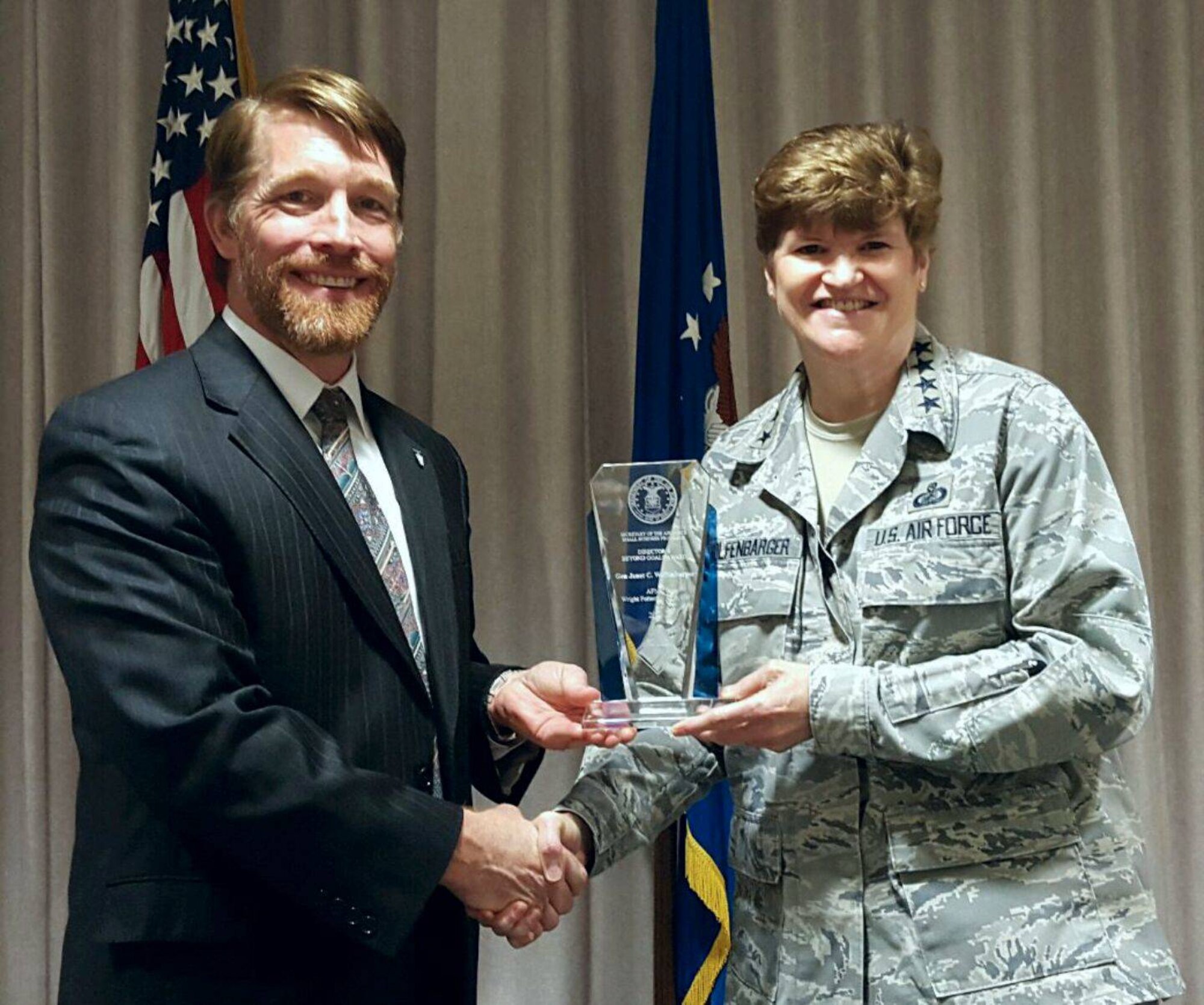 Mark Teskey, Air Force Director of Small Business Programs, presents Gen. Janet Wolfenbarger, Air Force Materiel Command commander, the 2014 Secretary of the Air Force Small Business Director’s Beyond Goals Award. (U.S. Air Force photo/Stacey Geiger)