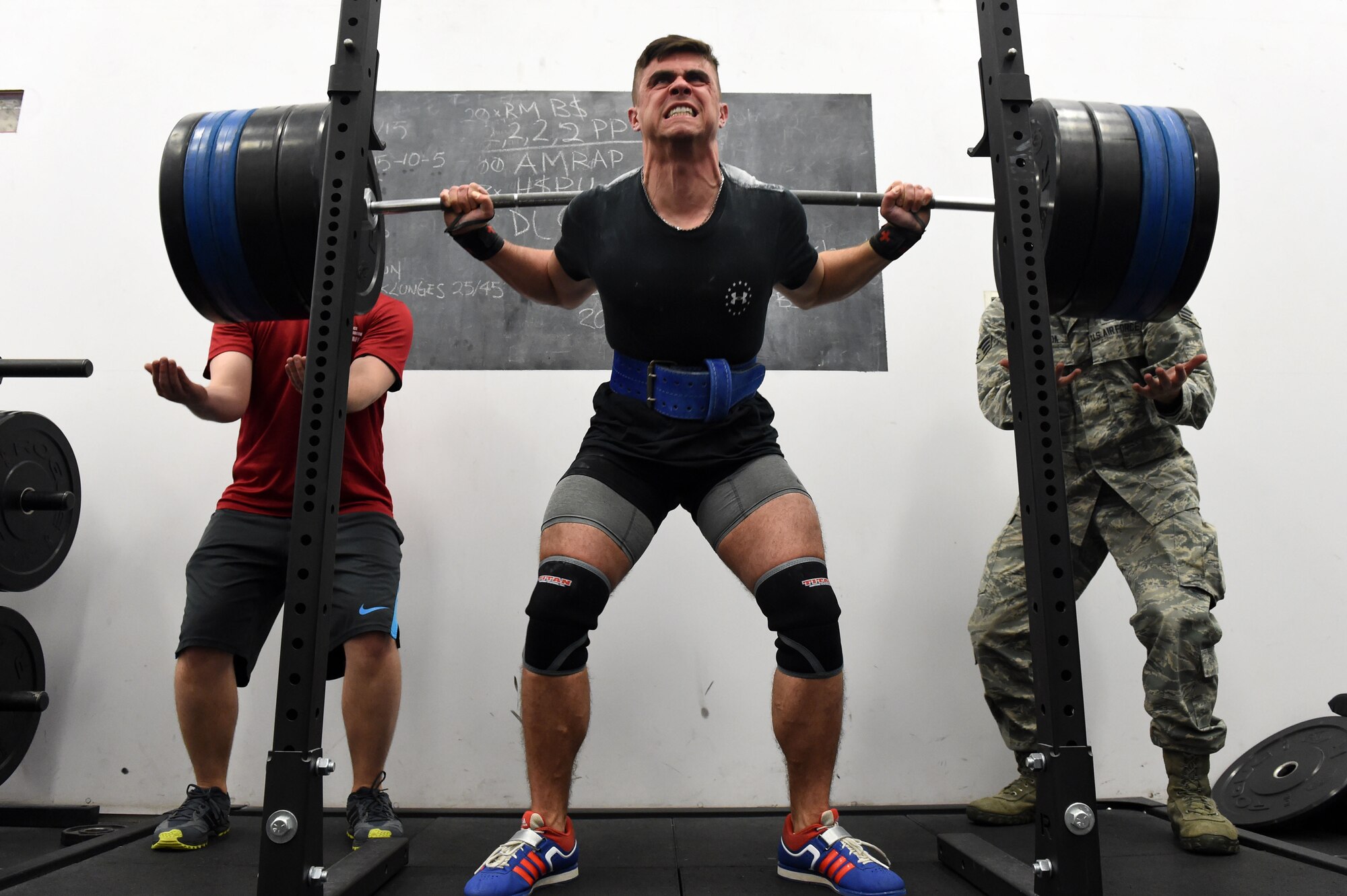 Senior Airman Jacob Horton, 460th Contracting Flight contracting specialist, squats during the Tri-Wing Sports Day competition May 20, 2015, on Buckley AFB, Colo. Tri-Wing Sports Day is held once a year between the three Air Force Space Command bases and is intended to promote healthy, active lifestyles and friendly competition. The bases competed against each other in over 15 sports such as volleyball, football, tennis and softball among others. (U.S. Air Force photo by Airman 1st Class Emily E. Amyotte/Released)